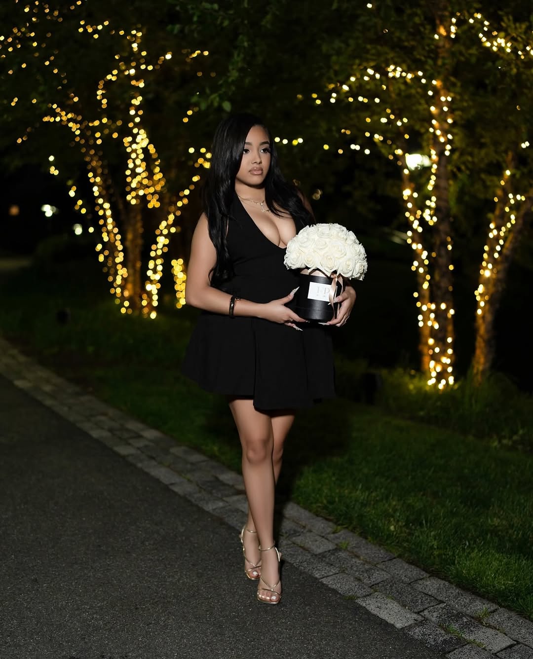 Client with FP hatbox of white roses and golden string lights