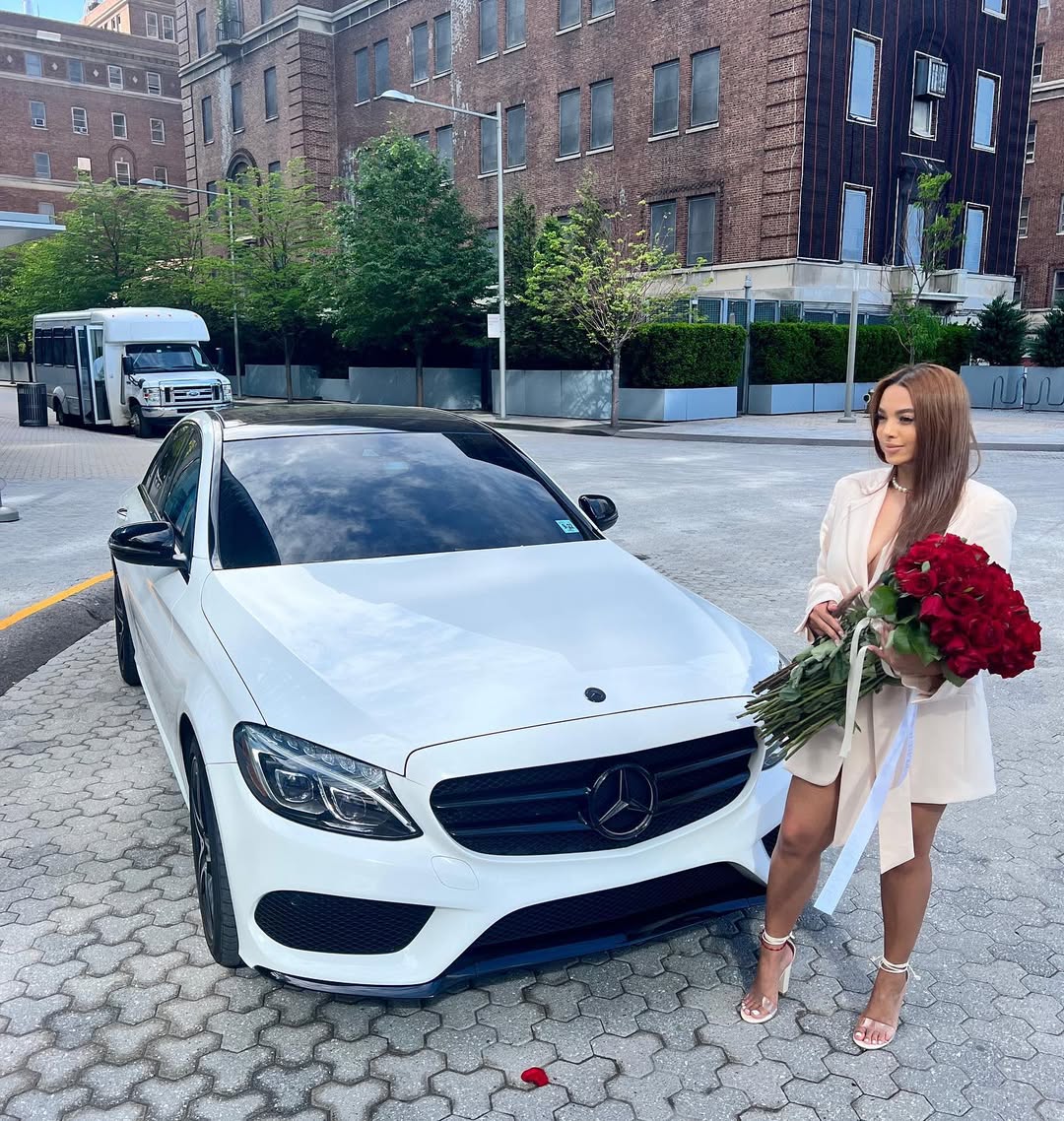 Client with beautiful red rose bouquet in elegant setting